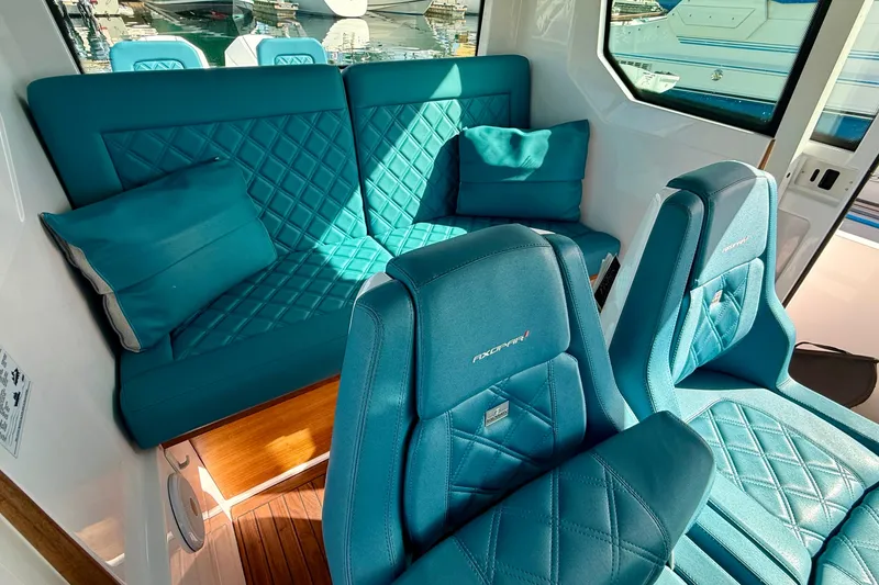 Slide: The Image of Luxurious interior of 2021 Axopar Brabus 28 Cabin with teal quilted seating. - 50