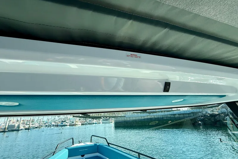 Slide: The Image of Interior view of 2021 Axopar Brabus 28 Cabin boat with marina background. - 51