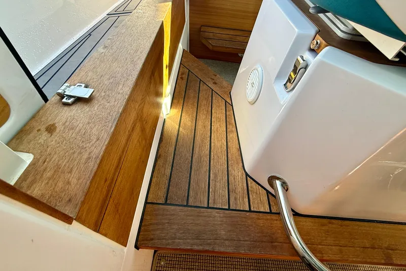 Slide: The Image of Interior view of 2021 Axopar Brabus 28 Cabin with wooden flooring and sleek design. - 54