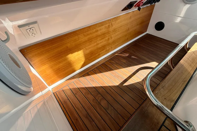 Slide: The Image of Interior of 2021 Axopar Brabus 28 Cabin with wood paneling and speaker. - 57