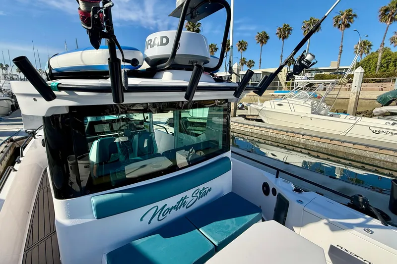 Slide: The Image of 2021 Axopar Brabus 28 Cabin boat docked, featuring sleek design and modern equipment. - 8