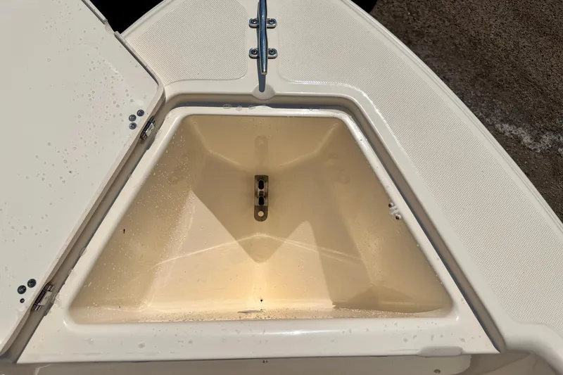 Slide: The Image of Open storage compartment on 2017 Scout 175 Sportfish boat, showing interior details. - 11