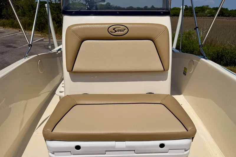 Slide: The Image of 2017 Scout 175 Sportfish boat with tan cushioned seating in the cockpit area. - 13