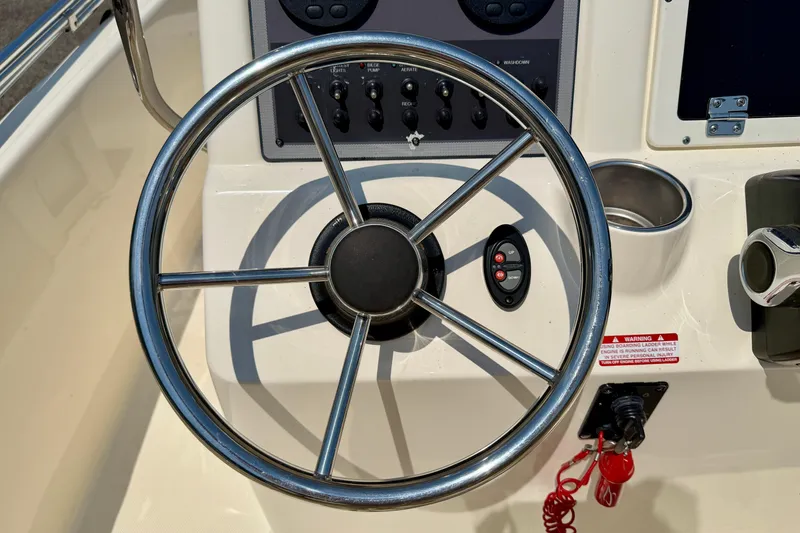 Slide: The Image of Steering wheel and controls of a 2017 Scout 175 Sportfish boat. - 15