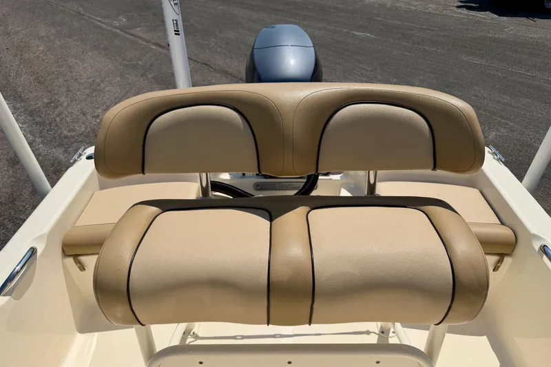 Slide: The Image of 2017 Scout 175 Sportfish boat with tan cushioned seating and visible outboard motor. - 19