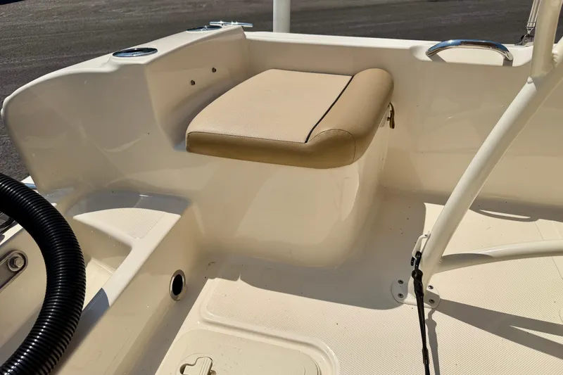 Slide: The Image of 2017 Scout 175 Sportfish boat interior with beige cushioned seat and white deck. - 22