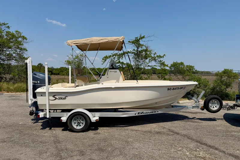 Slide: The Image of 2017 Scout 175 Sportfish boat on trailer with canopy, parked outdoors. - 4