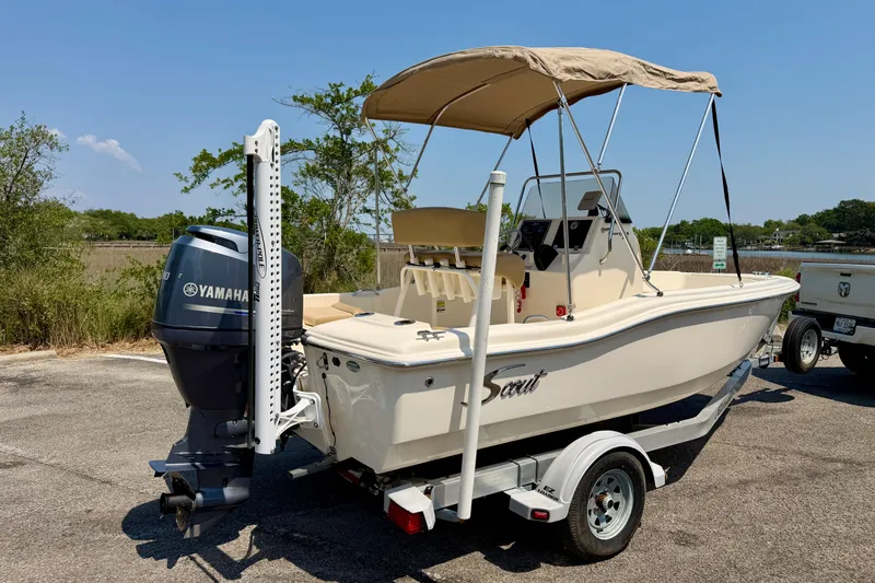 Slide: The Image of 2017 Scout 175 Sportfish boat with Yamaha engine on trailer, parked outdoors. - 6