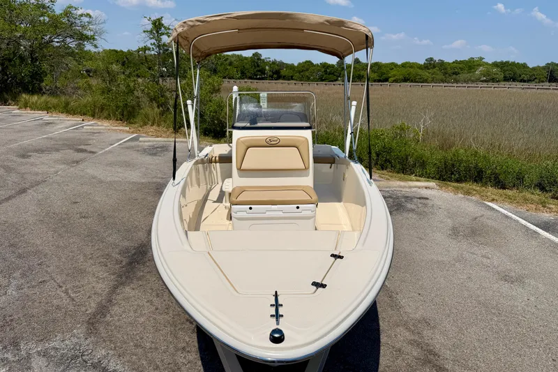 Slide: The Image of 2017 Scout 175 Sportfish boat with canopy, parked near marshland. - 7