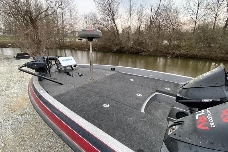 Slide: The Image of 2011 Ranger Z520 boat with fishing equipment on a riverbank. - 10