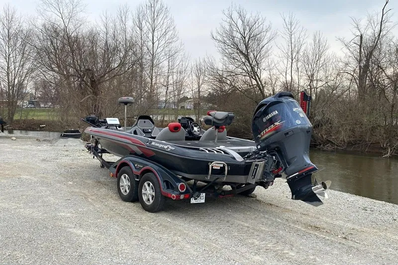 Slide: The Image of 2011 Ranger Z520 boat with Yamaha motor on trailer near riverbank. - 12