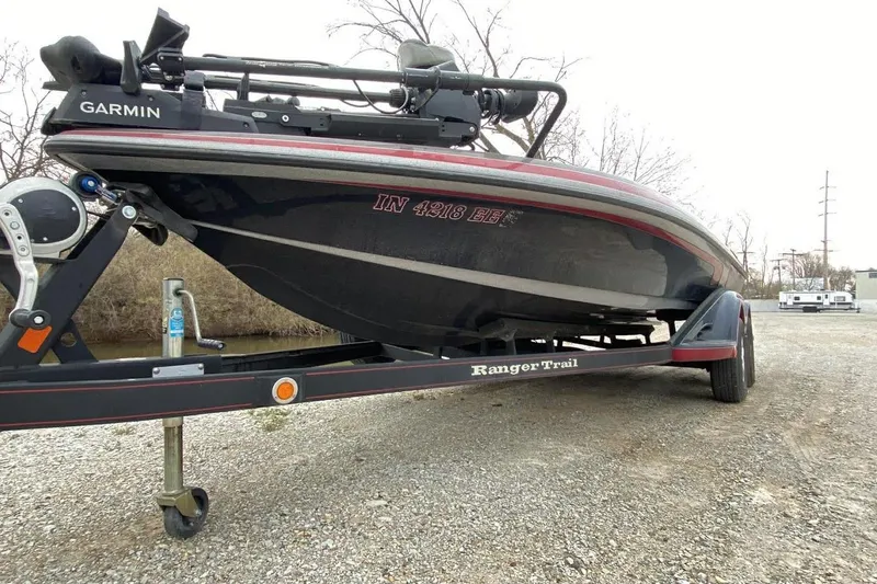 Slide: The Image of 2011 Ranger Z520 boat on trailer with Garmin equipment, parked on gravel. - 3
