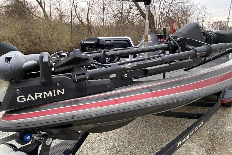 Slide: The Image of 2011 Ranger Z520 boat with Garmin equipment on a trailer, surrounded by trees. - 7