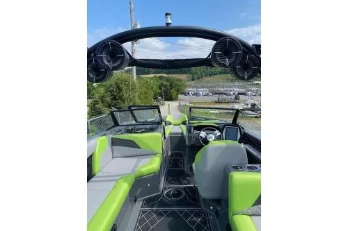 Slide: The Image of 2022 Tigé Z3 boat interior with green and gray seating, steering wheel, and speakers. - 6