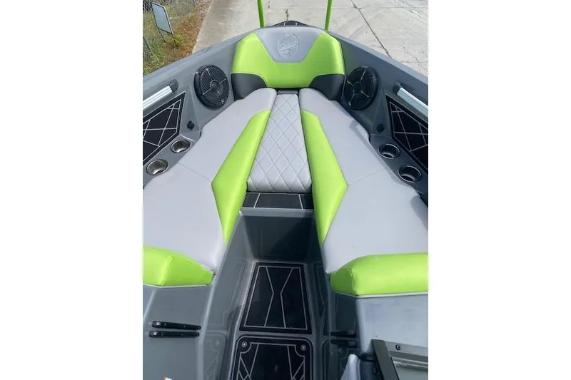 Slide: The Image of 2022 Tigé Z3 boat interior with green and gray seating, cup holders, and speakers. - 8