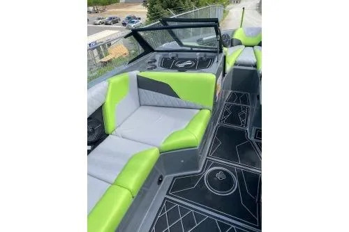Slide: The Image of 2022 Tigé Z3 boat interior with green and gray seating, modern dashboard, and stylish flooring. - 9
