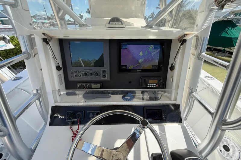 Slide: The Image of 2006 SeaVee 290B boat dashboard with navigation screens and steering wheel. - 14