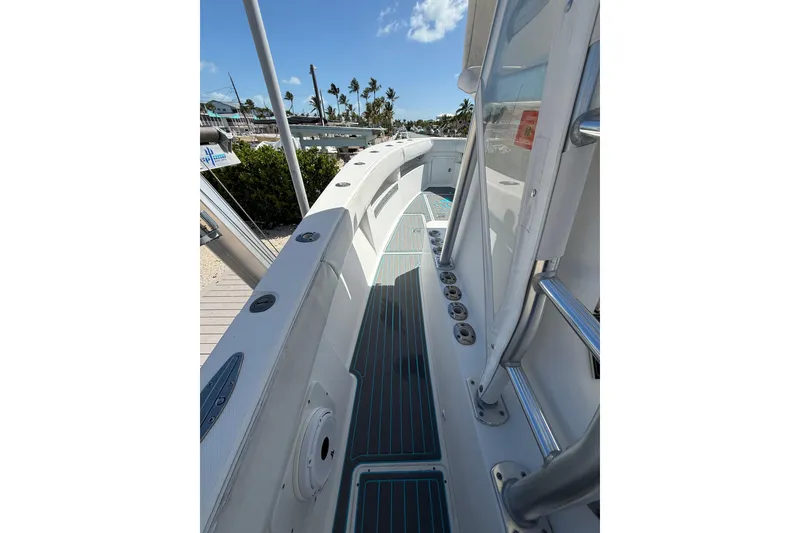 Slide: The Image of 2006 SeaVee 290B boat deck with rod holders and clear skies. - 15