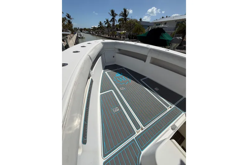 Slide: The Image of 2006 SeaVee 290B boat deck with custom flooring, docked near palm trees. - 16
