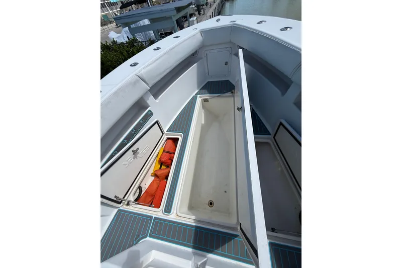 Slide: The Image of 2006 SeaVee 290B boat deck with open storage compartments and safety gear. - 24