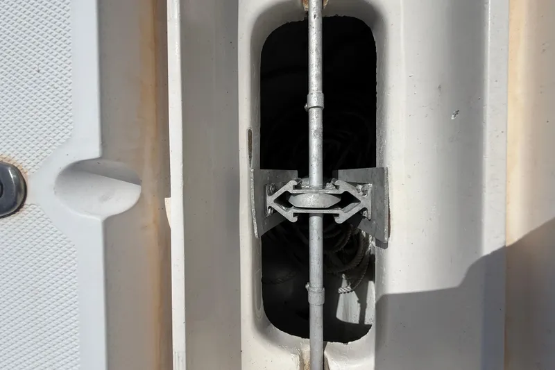 Slide: The Image of Close-up of a 2006 SeaVee 290B boat component, featuring a metal rod and bracket. - 25