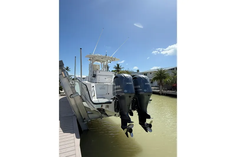 Slide: The Image of 2006 SeaVee 290B boat with twin Yamaha 300 engines on a lift. - 3