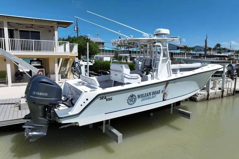 Slide: The Image of 2006 SeaVee 290B boat docked with Yamaha engine, featuring custom graphics. - 32