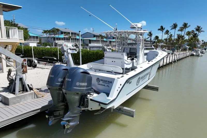 Slide: The Image of 2006 SeaVee 290B boat docked with twin Yamaha engines, in a sunny marina setting. - 33