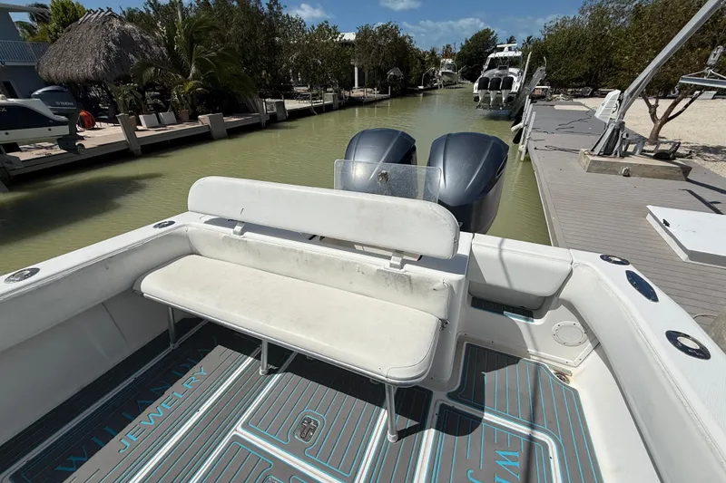 Slide: The Image of 2006 SeaVee 290B boat with twin engines docked in a serene canal setting. - 4