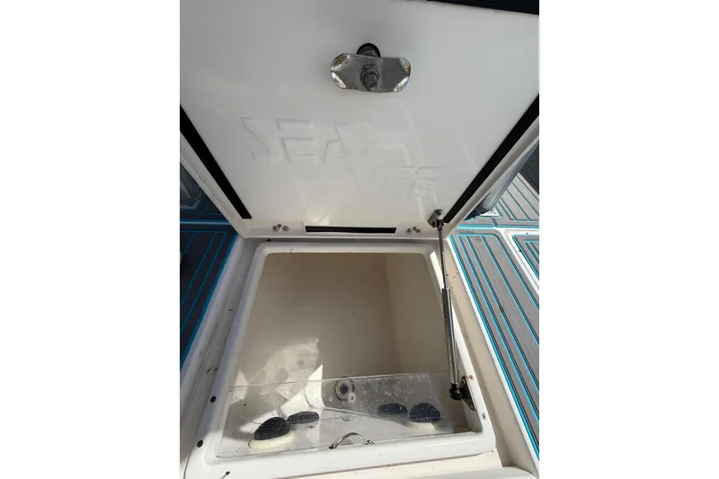 Slide: The Image of Open storage compartment on a 2006 SeaVee 290B boat, featuring a sturdy latch. - 5