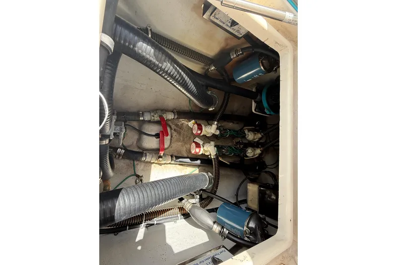 Slide: The Image of Engine compartment of a 2006 SeaVee 290B boat, showing hoses and mechanical components. - 6