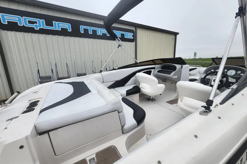 Slide: The Image of 2006 Reinell 220 LSE boat interior with white seating, near Aqua Marine building. - 3