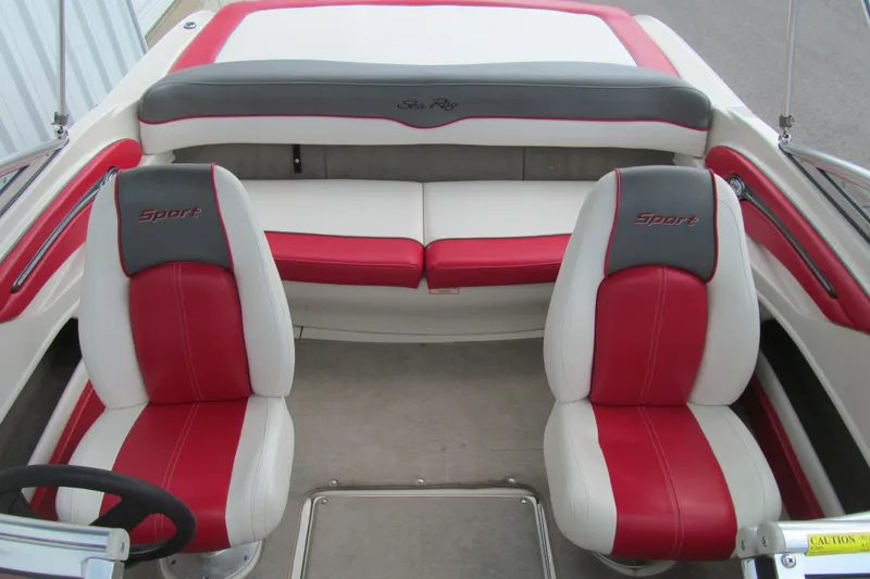 Slide: The Image of 2006 Sea Ray 205 Sport boat interior with red and white seating. - 12