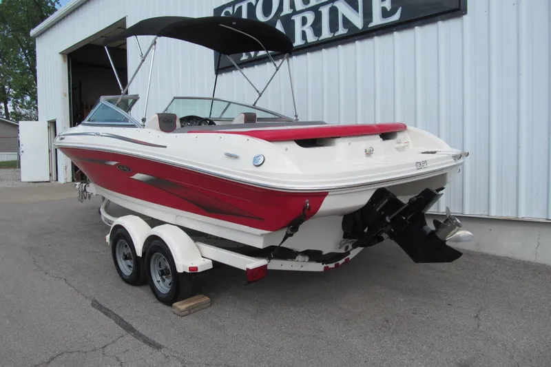 Slide: The Image of 2006 Sea Ray 205 Sport boat with red and white design on a trailer. - 3