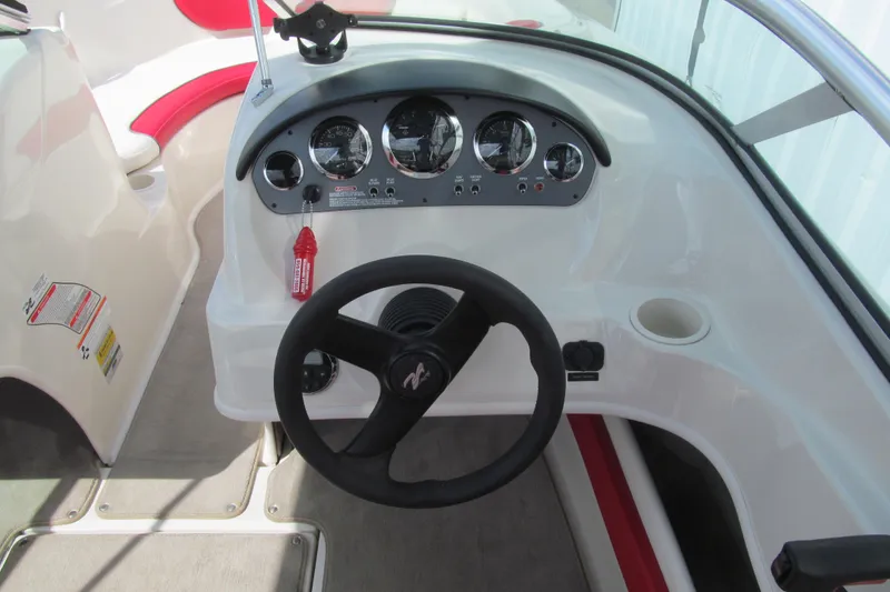 Slide: The Image of Steering console of a 2006 Sea Ray 205 Sport boat with gauges and controls. - 6