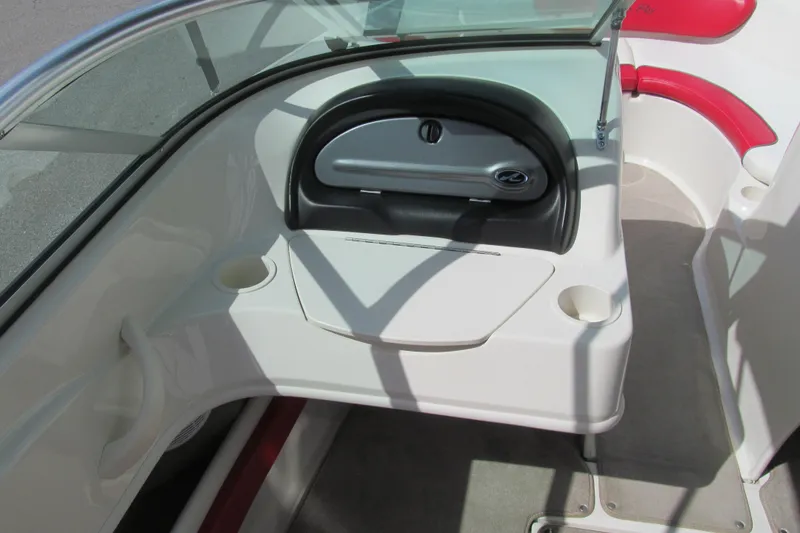 Slide: The Image of 2006 Sea Ray 205 Sport boat interior with red and white seating, cup holders, and dashboard. - 7