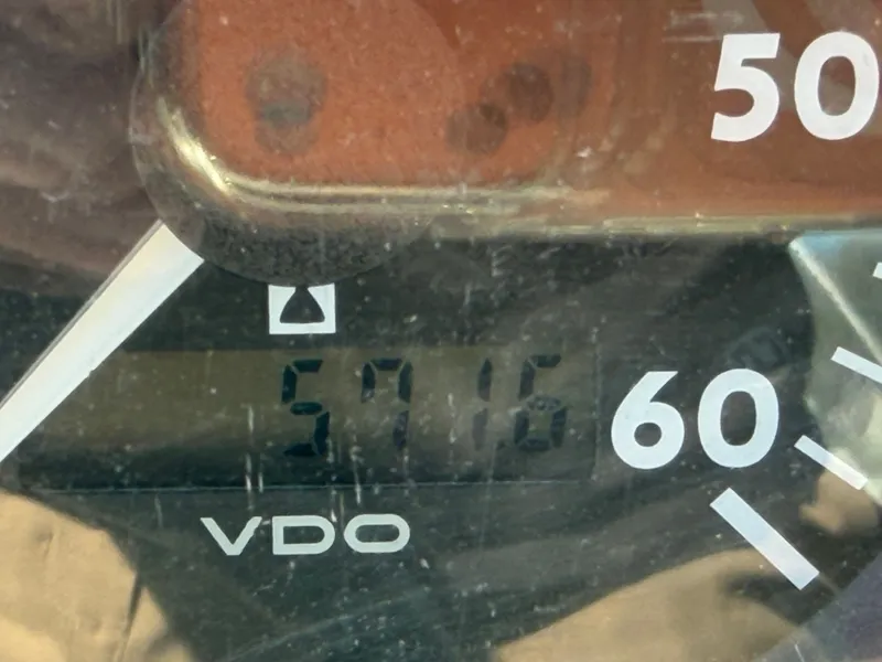 Slide: The Image of Close-up of a VDO speedometer, displaying 57.16 miles. - 28