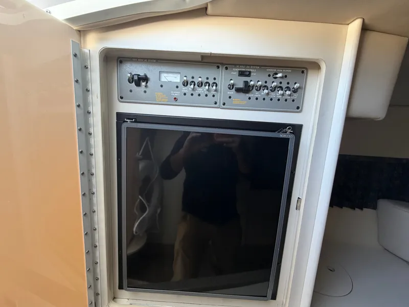 Slide: The Image of Control panel and fridge in 2002 Formula 330 Sun Sport boat. - 40