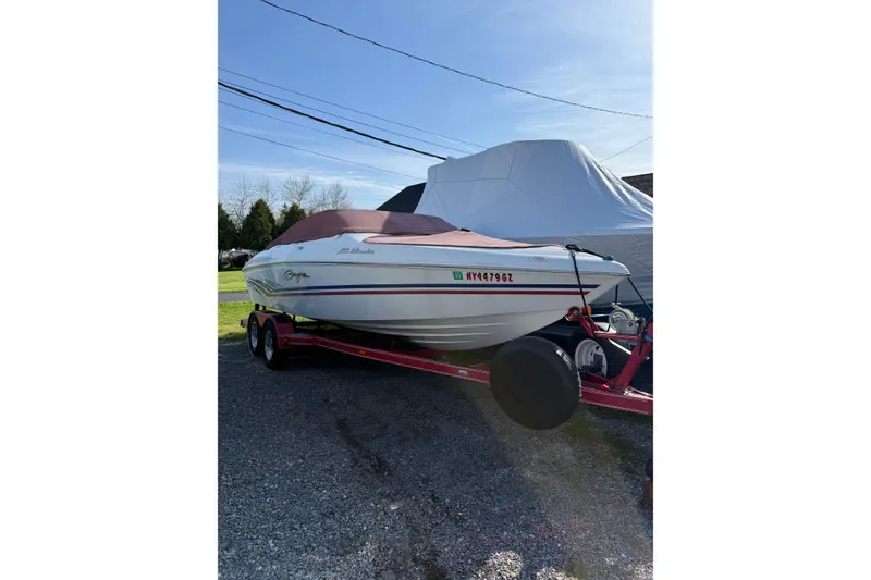 The Image of 1999 Baja 212 Islander boat on trailer, covered and parked outdoors. - 0