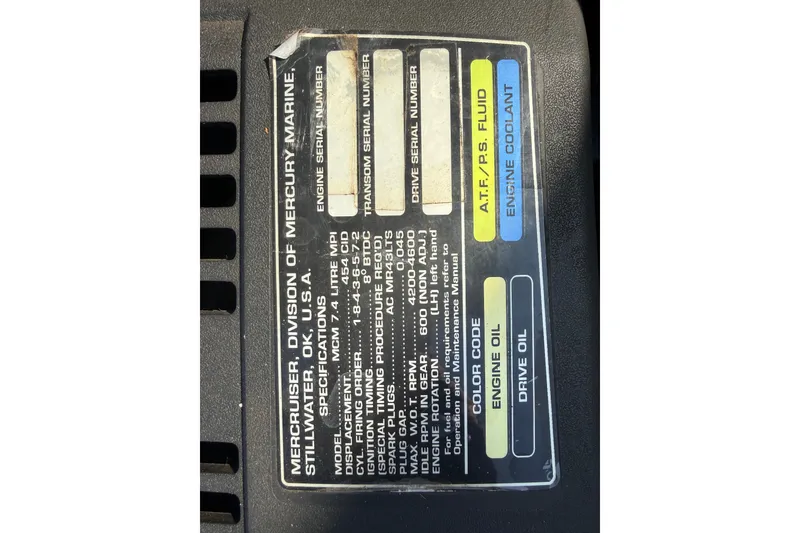 Slide: The Image of Label on a 1999 Baja 212 Islander engine, detailing specifications and fluid types. - 2