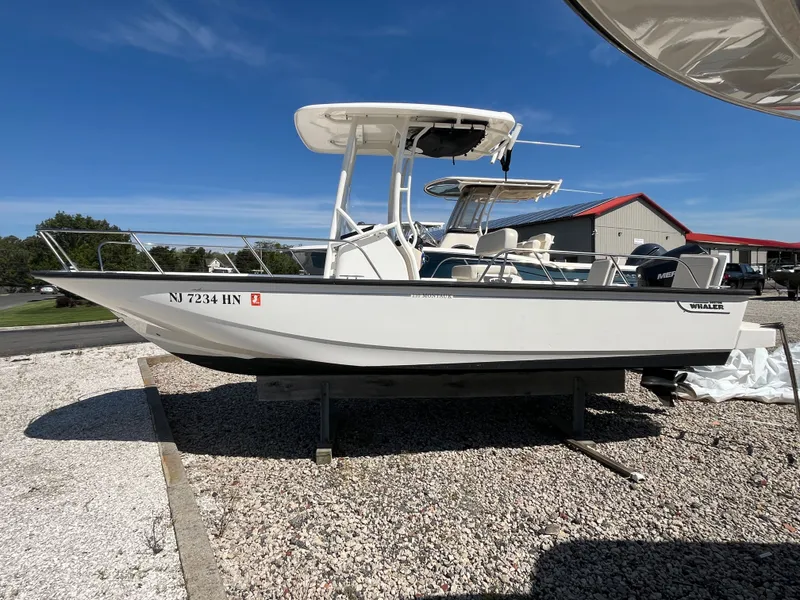 Slide: The Image of 2021 Boston Whaler 210 Montauk boat on gravel surface. - 0
