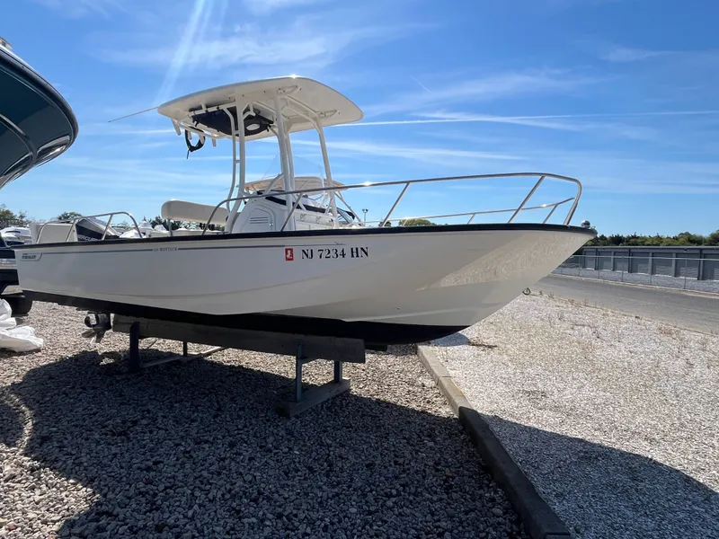 Slide: The Image of 2021 Boston Whaler 210 Montauk boat on gravel lot. - 1