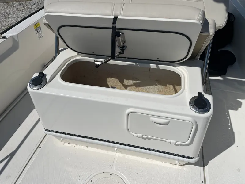 Slide: The Image of 2021 Boston Whaler 210 Montauk boat storage compartment open. - 11