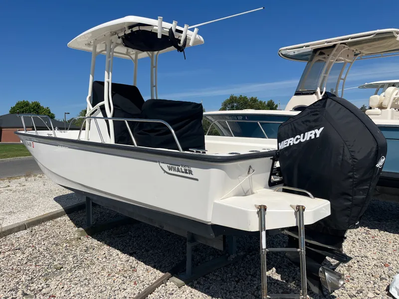 Slide: The Image of 2021 Boston Whaler 210 Montauk boat parked on gravel lot. - 6