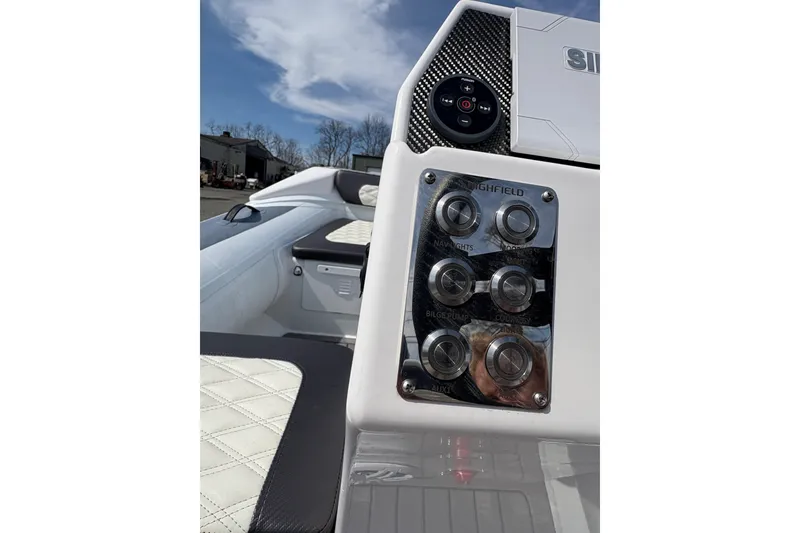 Slide: The Image of 2024 Highfield Sport 360 boat dashboard with control panel and seating. - 12