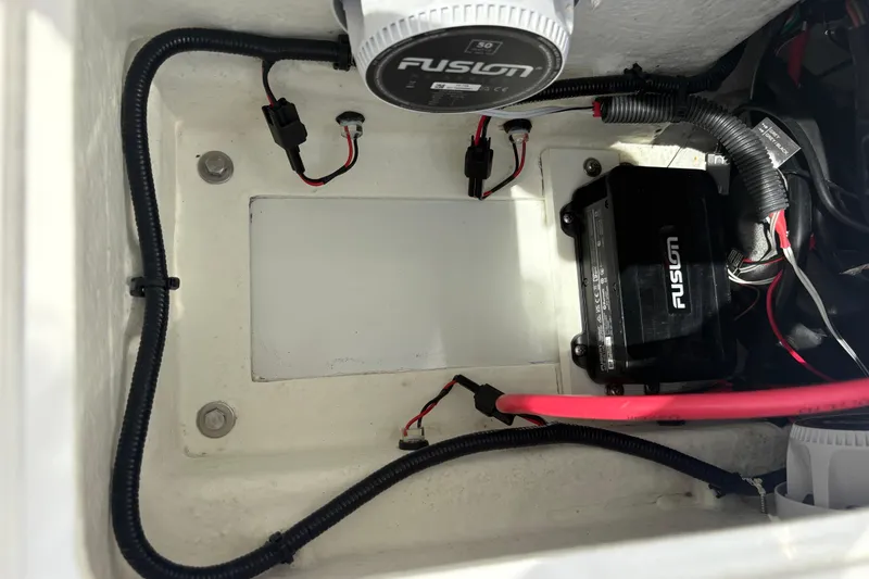 Slide: The Image of Electrical components inside a 2024 Highfield Sport 360 boat, featuring Fusion equipment. - 20