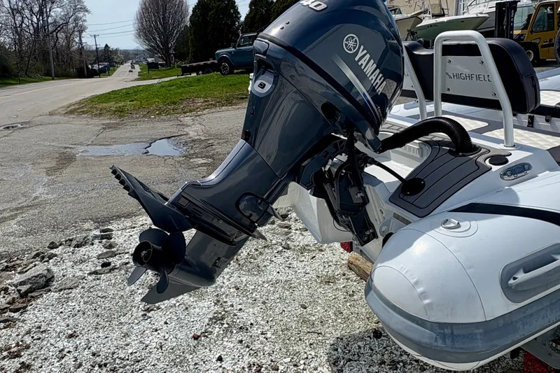 Slide: The Image of 2024 Highfield Sport 360 boat with Yamaha outboard motor on gravel surface. - 4