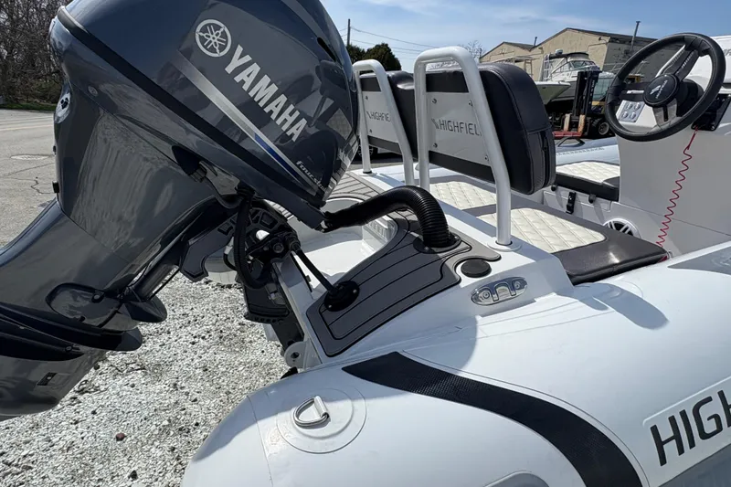 Slide: The Image of 2024 Highfield Sport 360 boat with Yamaha outboard motor, featuring sleek seating and controls. - 9