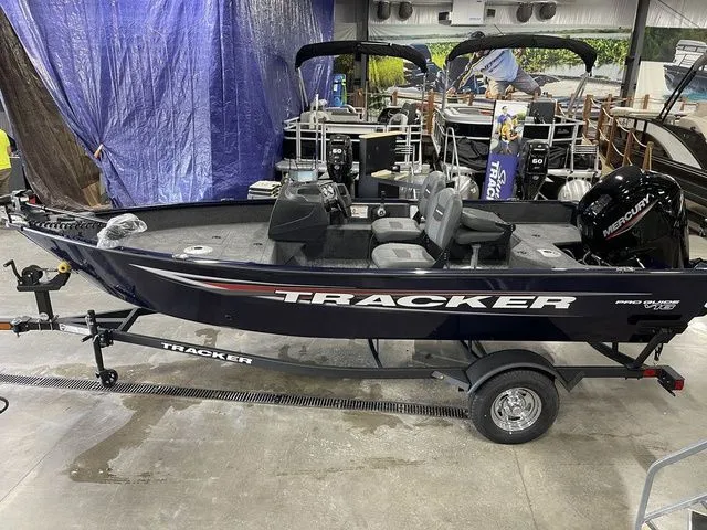 Slide: The Image of 2026 Tracker Pro Guide V-16 SC boat in a showroom. - 11