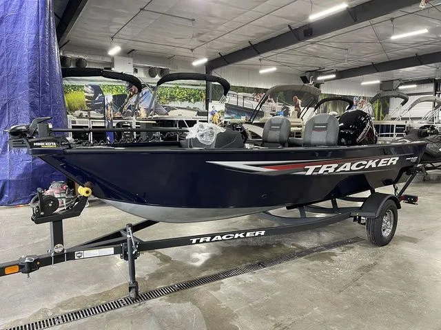 Slide: The Image of 2026 Tracker Pro Guide V-16 SC boat in a showroom. - 12